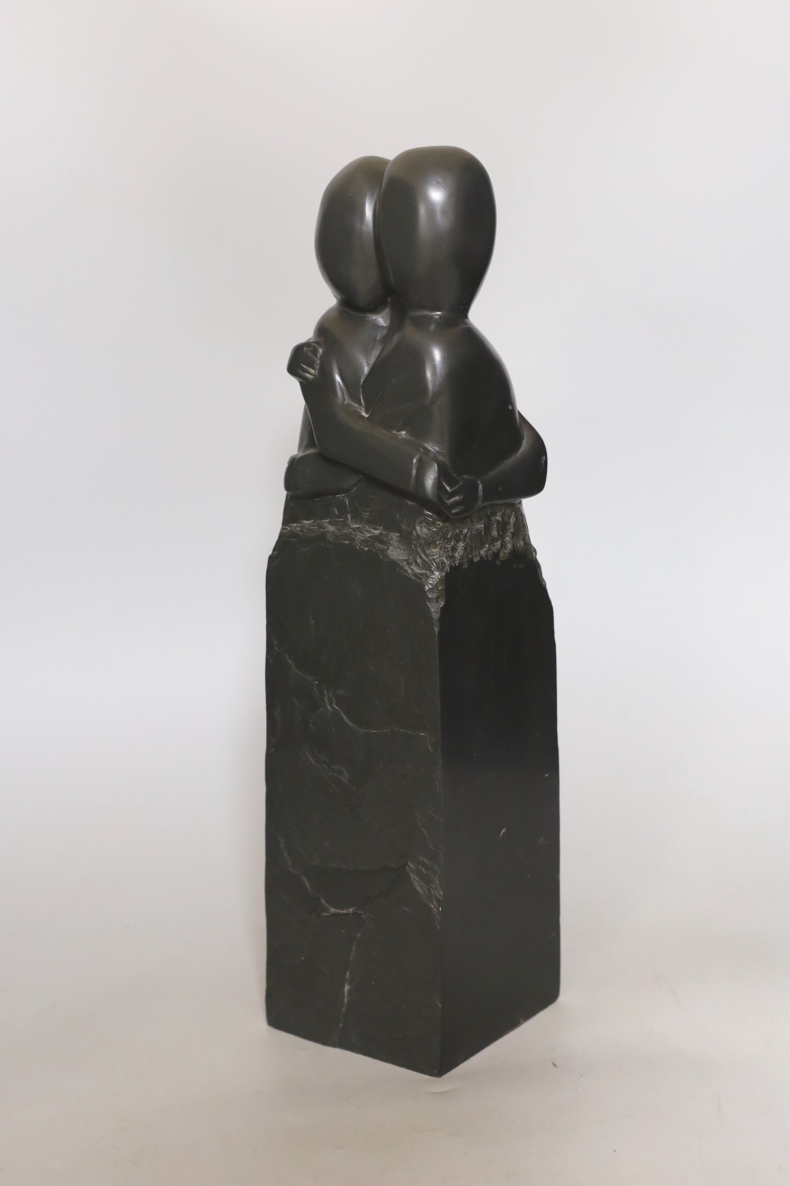A Canadian Inuit type carved stone figure group, 43cm high